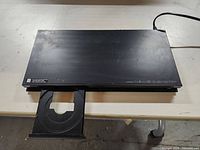 Front view of Sony Blu-ray player with disc tray open showing device top surface and tray.