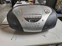 Front view of Sony boombox showing CD player lid, speaker grills, digital display, and control buttons.