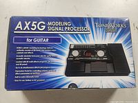 Box of ToneWorks Korg AX5G Modeling Signal Processor showing branding, product image, and features.