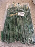 sealed plastic package with green stakes visible
