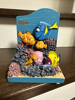 Front view showing Dory, Nemo, Marlin, seahorse, octopus, reef fish on coral