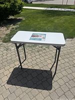 Table unfolded showing top surface and legs