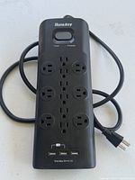 Front view of Huntkey power strip showing outlets, USB ports, switch, cord