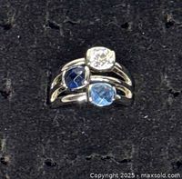 Front view of silver-tone ring showing all three bezel-set stones