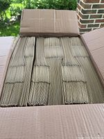 Open carton showing stacked kraft paper bags