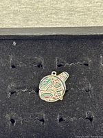 Front of orca enamel charm showing Indigenous design and loop