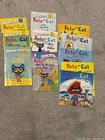 Front view of all 11 Pete the Cat paperback books arranged on floor