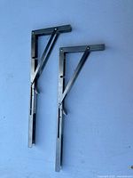 Both stainless steel folding brackets fully extended showing hinge and lock arms