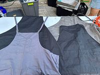 All four aprons laid out showing colors and pockets