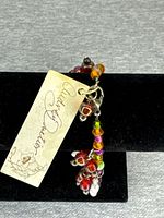 Bracelet close-up showing tag and bead clusters