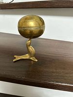 Full view brass seal balancing closed sphere music box