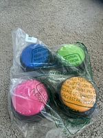 Front of sealed bag showing four colored buttons