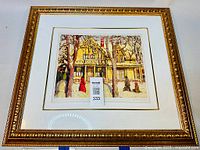 Front view of entire framed print showing ornate gold frame and white mat