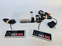 NES Mini clone system with controllers and all cords neatly arranged for display.