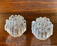 Pair of clear glass Kosta Boda Polar Series candlestick holders with textured icicle-like design.
