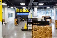 Interior of XYZ Storage office showing customer service desk, packing supplies, and specialty boxes.