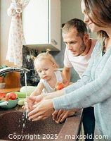 Lifestyle photo showing family using water tap, representing water softener use context.