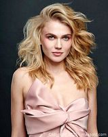 Model with styled blonde hair showcasing potential hair salon services.