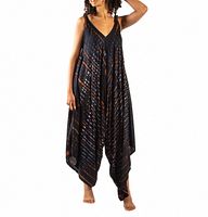 Woman modeling a flowing black and rust striped jumpsuit with wide legs and V-neck.
