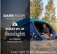 Marketing graphic showing a person inside a partially collapsed pop-up tent with Dark Room technology label