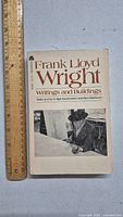 Front cover of the vintage book Frank Lloyd Wright: Writings and Buildings, showing title and black and white photo of Wright.