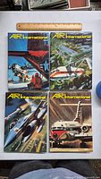 Four Air International hardcover magazines issues 32-35 arranged side by side with ruler for scale, showing colorful illustrated covers featuring aircraft.
