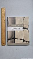 Front cover of the book showing title and concrete imagery with ruler for scale