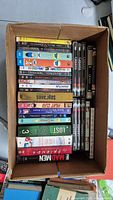 Top view of box showing a mixed assortment of DVDs including TV series and movies