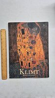 Front cover of the art book featuring Gustav Klimt artwork with gold and black geometric and abstract pattern design and title 'KLIMT Maria Costantino'