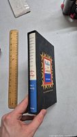 Side view of the Profiles in Courage book in slipcase with a ruler for scale