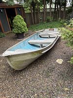 Front exterior view of aluminum boat on gravel