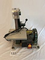 Side view showing sanding belt, work table, power switch and Craftex label on motor housing.