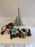 Full lot showing anchor, buoys, rope arranged on white cloth background