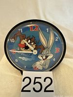 Photo showing front view of the round clock with Bugs Bunny and Tasmanian Devil on the face.