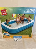 Box of Play Day 10-foot Family Pool showing image of pool with people and beach ball on grass.