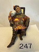 Front view of the Royal Doulton figurine 'The Foaming Quart' showing the seated man holding a beer stein.