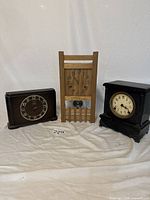 Three vintage table top clocks side by side showing overall look and condition