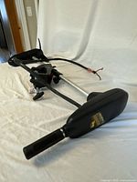 Full view of the trolling motor showing the tiller handle, shaft and motor mount