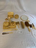 Full set of vintage grooming items laid out showing mirror, brushes, containers, shoehorn, and tools.