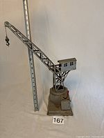 Full view of crane with ruler showing height and overall condition