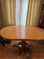 Wood dining table showing overall shape, wood grain, and wear such as discoloration spot