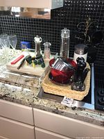 Full countertop view showing all kitchen items including spices, mugs, pot, and colander.