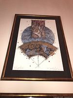 Framed abstract art print featuring geometric and curved shapes in muted colors, signed by artist in lower corners.