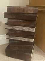 Wood side table stacks to resemble old books showing overall view.
