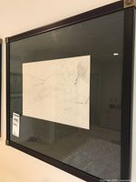 Framed black and white nude figure sketch on paper, with dark wood frame and mat board, showing full artwork and signature in lower right.