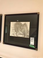 Full view of the framed sketch showing the nude figure with black mat and decorative corner frame elements.
