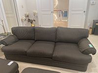 Front view of the full sofa showing upholstery fabric pattern and cushion arrangement.