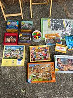 Overview of all puzzles, coloring books, card packs, and letter cut-outs displayed on a carpeted floor
