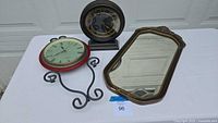 Lot overview showing two clocks and one mirror against a white background.