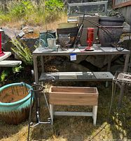 Overview of potting table with planters, bench and planter box below